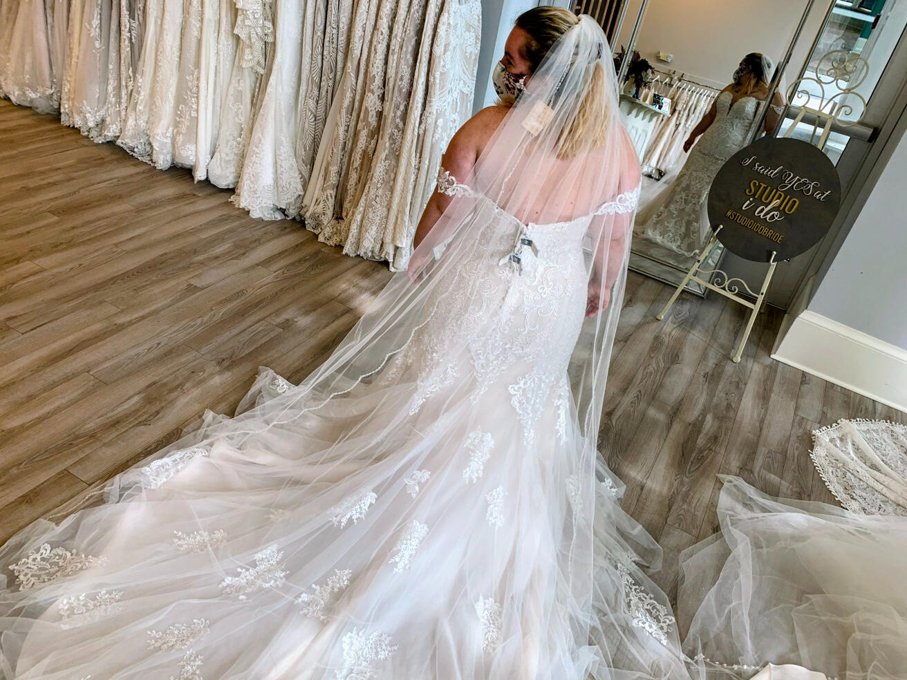 Small layered cake and straw hat on a brown chair surrounded by yellow flowers
